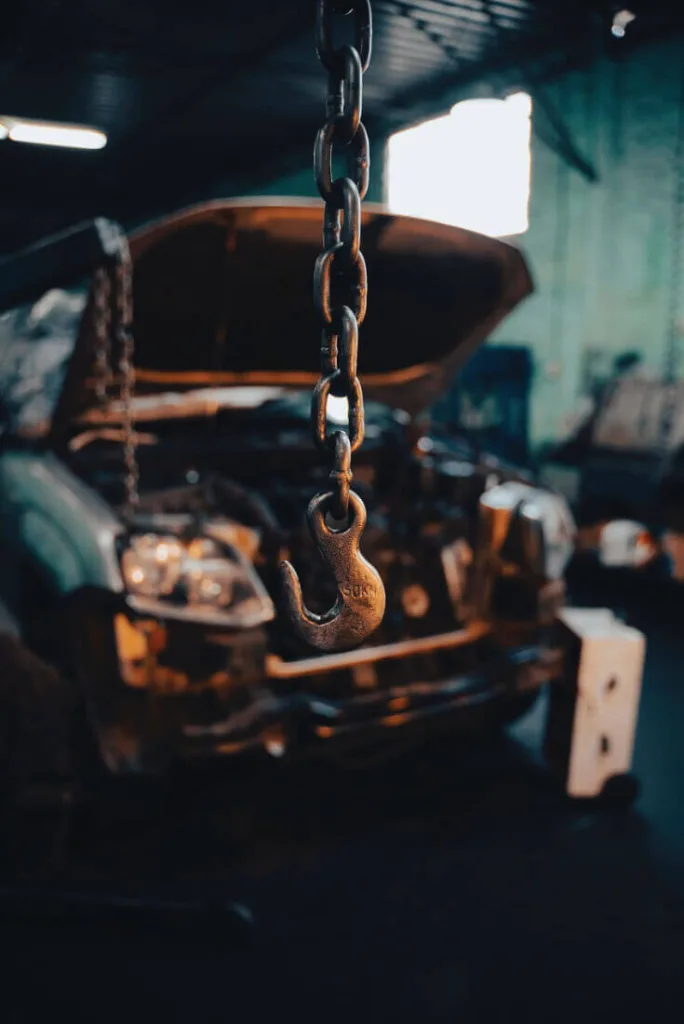 A Quicktime Autocentres technician performing vehicle maintenance in a professional garage setting.